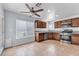 Updated kitchen features stainless steel appliances, granite countertops, wood cabinets, and a ceiling fan at 503 Credence Ave, Henderson, NV 89002