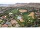 Aerial view of the golf course with ponds and lush trees surrounded by homes at 5079 Quiet Falls Ct, Las Vegas, NV 89141