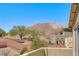 Backyard view from balcony with desert landscape and brick retaining wall at 5079 Quiet Falls Ct, Las Vegas, NV 89141