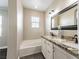 Bathroom featuring double sinks with granite countertops and a separate tub at 5079 Quiet Falls Ct, Las Vegas, NV 89141