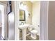 View of a half bathroom featuring a pedestal sink and a decorative mirror at 5079 Quiet Falls Ct, Las Vegas, NV 89141