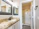 Bathroom features granite countertops, decorative mirrors, and a walk-in shower at 5079 Quiet Falls Ct, Las Vegas, NV 89141