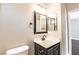 Well-lit bathroom with a single vanity, dark fixtures, and decorative mirrors at 5079 Quiet Falls Ct, Las Vegas, NV 89141