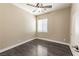 Neutral bedroom featuring wood-look floors, ceiling fan, bright window, and fresh white trim at 5079 Quiet Falls Ct, Las Vegas, NV 89141