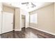 Clean bedroom offers hardwood floors, neutral walls, ceiling fan, window and walk-in closet at 5079 Quiet Falls Ct, Las Vegas, NV 89141