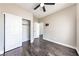 This bedroom offers hardwood floors, neutral walls, ceiling fan, and closet with sliding doors at 5079 Quiet Falls Ct, Las Vegas, NV 89141