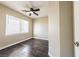 Bright bedroom featuring a ceiling fan, window with blinds, and hardwood floors at 5079 Quiet Falls Ct, Las Vegas, NV 89141