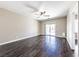 Bright bedroom with hardwood floors, a ceiling fan, and sliding door access to outdoor space at 5079 Quiet Falls Ct, Las Vegas, NV 89141