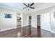 Large primary bedroom with wood floors and ensuite bathroom at 5079 Quiet Falls Ct, Las Vegas, NV 89141