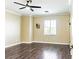 Cozy bedroom with hardwood flooring, a ceiling fan, and plenty of natural light at 5079 Quiet Falls Ct, Las Vegas, NV 89141