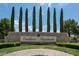 Stone Southern Highlands community entrance with manicured landscaping and mature trees at 5079 Quiet Falls Ct, Las Vegas, NV 89141