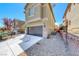 Contemporary two-story home features a two-car garage and low-maintenance gravel landscaping at 5079 Quiet Falls Ct, Las Vegas, NV 89141