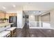 View of the living room featuring hardwood floors, kitchen with stainless steel refrigerator and a second-floor landing at 5079 Quiet Falls Ct, Las Vegas, NV 89141
