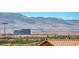 Scenic mountain view showcasing the Allegiant Stadium over a residential area and treetops at 5079 Quiet Falls Ct, Las Vegas, NV 89141