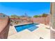 Private backyard oasis with a refreshing pool, concrete patio, and desert landscaping at 5079 Quiet Falls Ct, Las Vegas, NV 89141