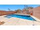 Beautiful backyard pool with stone coping and desert landscape design at 5079 Quiet Falls Ct, Las Vegas, NV 89141
