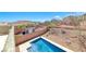 Private in-ground pool in backyard with a view of the desert landscaping and mountains at 5079 Quiet Falls Ct, Las Vegas, NV 89141