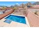 Private in-ground pool in backyard with a view of the desert landscaping at 5079 Quiet Falls Ct, Las Vegas, NV 89141