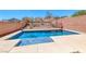 Private in-ground pool in backyard with a view of the desert landscaping at 5079 Quiet Falls Ct, Las Vegas, NV 89141