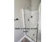 Close up of the walk-in shower with glass enclosure, tiled walls and gray tiled floors at 5079 Quiet Falls Ct, Las Vegas, NV 89141