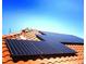 Close-up of the installed solar panels on a red tile roof at 5079 Quiet Falls Ct, Las Vegas, NV 89141