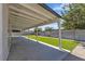 Covered back patio area, features manicured artificial turf, and a block fence at 5079 Reno Ct, Las Vegas, NV 89119