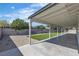 Covered back patio with a view of the backyard's landscaping features and fenced perimeter at 5079 Reno Ct, Las Vegas, NV 89119