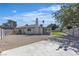 Spacious backyard featuring artificial turf, a tall chimney, and a paved area at 5079 Reno Ct, Las Vegas, NV 89119