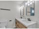 Modern bathroom featuring a double sink vanity, two mirrors, and updated fixtures at 5079 Reno Ct, Las Vegas, NV 89119