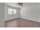 Bedroom features hardwood floors, neutral color pallete, and large picture window at 5079 Reno Ct, Las Vegas, NV 89119