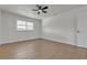 Well-lit bedroom showcasing a large window and hardwood flooring for a comfortable space at 5079 Reno Ct, Las Vegas, NV 89119