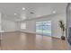 Bright open-concept living room with wood floors and sliding glass doors to the backyard at 5079 Reno Ct, Las Vegas, NV 89119