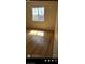 Sunlit bedroom featuring hardwood floors, a bright window, and neutral decor at 6024 Ripple Cloud Ct, North Las Vegas, NV 89031