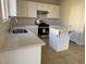 Bright kitchen with stainless steel appliances, white cabinets, and an eat-in kitchen island at 6024 Ripple Cloud Ct, North Las Vegas, NV 89031
