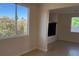 Bright living room with desert landscaping outside the windows, open floor plan and tile flooring at 6024 Ripple Cloud Ct, North Las Vegas, NV 89031