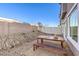 A fenced-in backyard featuring gravel landscaping, a patio, and an outdoor dining set at 6521 Cinnamon Hazelnut St # Lot 91, North Las Vegas, NV 89084