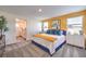 Bright bedroom featuring plush carpet, a bed with decorative pillows, and a bathroom at 6521 Cinnamon Hazelnut St # Lot 91, North Las Vegas, NV 89084
