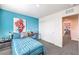 Well-lit bedroom with blue accent wall, desk, closet, and stylish decor for a modern feel at 6521 Cinnamon Hazelnut St # Lot 91, North Las Vegas, NV 89084