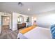Spacious bedroom featuring neutral carpet, stylish decor, and an ensuite bathroom at 6521 Cinnamon Hazelnut St # Lot 91, North Las Vegas, NV 89084