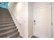 View of the front door and staircase with carpeted steps and white railing at 6521 Cinnamon Hazelnut St # Lot 91, North Las Vegas, NV 89084
