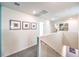 Upstairs hallway features neutral paint, carpet and artwork at 6521 Cinnamon Hazelnut St # Lot 91, North Las Vegas, NV 89084