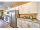 Modern kitchen with stainless steel appliances, gray countertops, and plenty of white cabinet storage at 6521 Cinnamon Hazelnut St # Lot 91, North Las Vegas, NV 89084