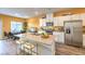 Modern kitchen featuring stainless steel appliances, white cabinets, and a spacious island at 6521 Cinnamon Hazelnut St # Lot 91, North Las Vegas, NV 89084