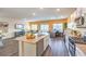 Open-concept floor plan with modern kitchen, dining area, and cozy living space with natural light at 6521 Cinnamon Hazelnut St # Lot 91, North Las Vegas, NV 89084
