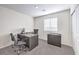 A well-lit office space features gray walls and carpet and a desk with a computer setup at 6521 Cinnamon Hazelnut St # Lot 91, North Las Vegas, NV 89084