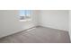 Cozy bedroom features neutral carpet and a bright window at 6712 Violet Cascade Ave, Las Vegas, NV 89156
