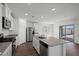 Bright kitchen with stainless steel appliances, a large island, and seamless access to the outdoor area through sliding glass doors at 6712 Violet Cascade Ave, Las Vegas, NV 89156