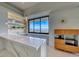 Modern bar area with marble countertops, open shelving, pendant lighting, and a stunning view at 677 Overlook Rim Dr, Henderson, NV 89012