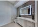 Sleek bathroom with floating vanity, integrated sink, and an illuminated mirror, creating a modern and serene space at 677 Overlook Rim Dr, Henderson, NV 89012