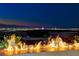 Modern fire feature with a view of the city skyline at night at 677 Overlook Rim Dr, Henderson, NV 89012